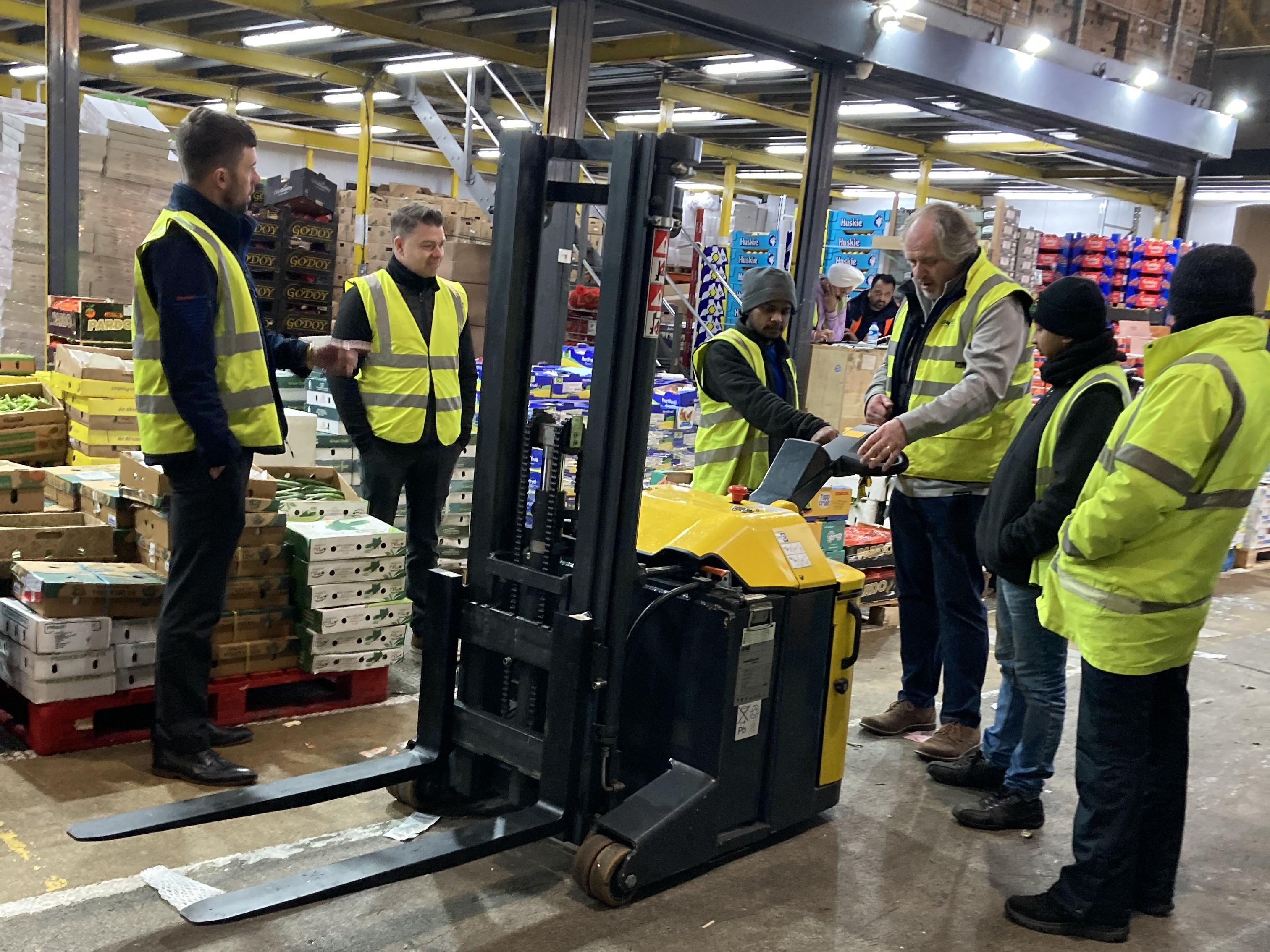 New Spitalfields Market customers demoing the Combilift CS pedestrian stacker.
